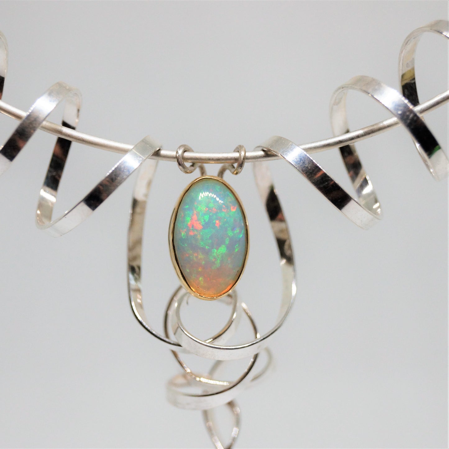 “Swirling enchantment” one of a kind opal neck piece