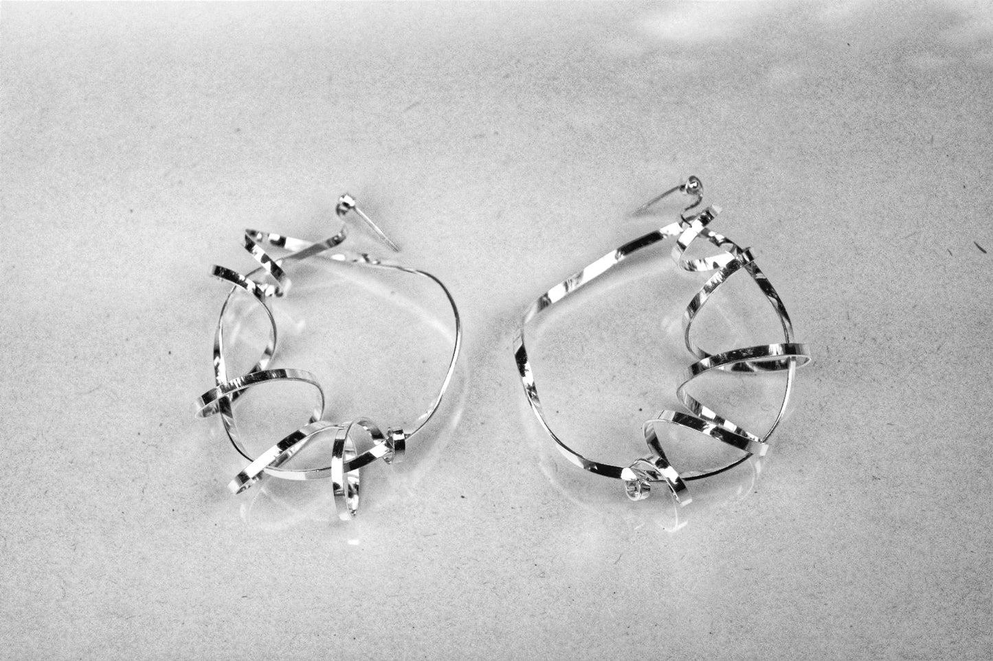 Sterling silver swirling magic statement hoops