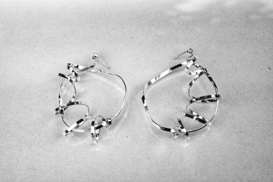 Sterling silver swirling magic statement hoops